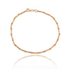 Pulsera de oro rosa de 18 quilates barra y esfera facetada.